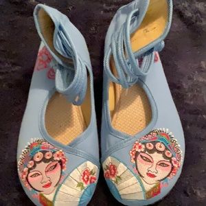 Made for me in Bejjing. Cute little shows with faces embroidered on toes